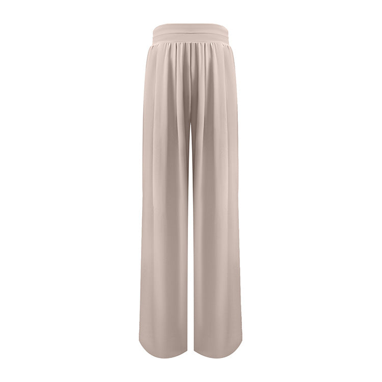 Beige high-waisted wide-leg flowy pants with pleated front displayed flat against white background