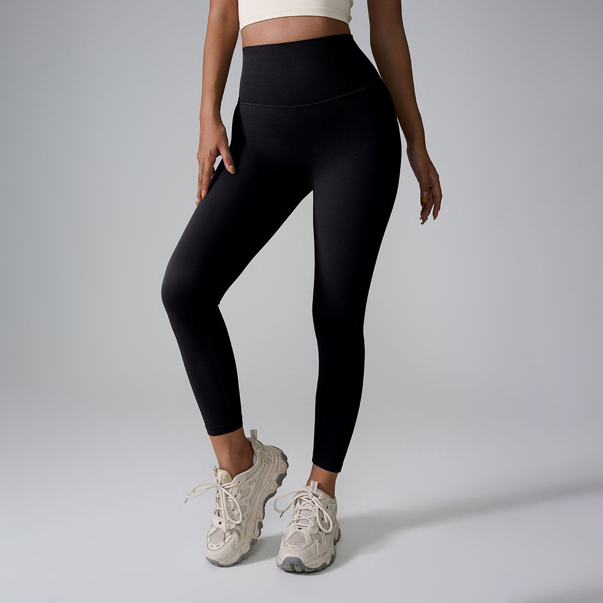 Woman wearing black high-waisted leggings with a seamless, form-fitting design