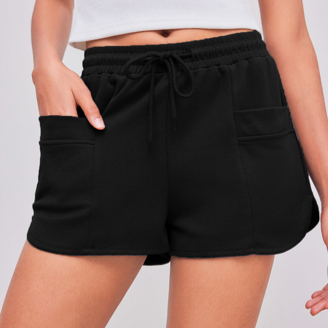 Black athletic shorts with drawstring waist, side pockets, relaxed fit design