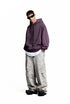 Purple oversized hoodie side view on model, drop shoulder