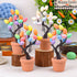 A set of four decorative Easter egg trees with vibrant pastel-colored eggs on dark twisted branches, placed in terracotta pots for a festive display.