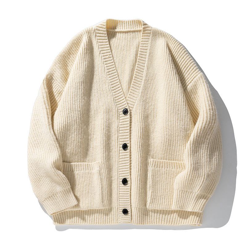 Cream ribbed cardigan with v-neck, four black buttons and front patch pockets displayed flat against white background
