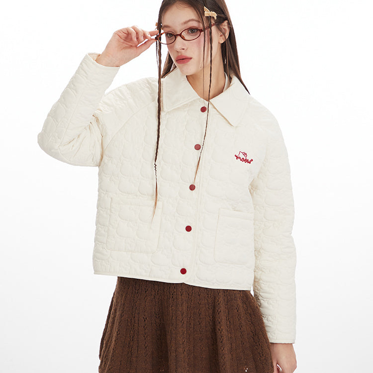 Woman wearing a white jacket with red buttons and a brown skirt on a white background