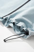 Sky blue windbreaker jacket hood brim and drawcord stopper detail