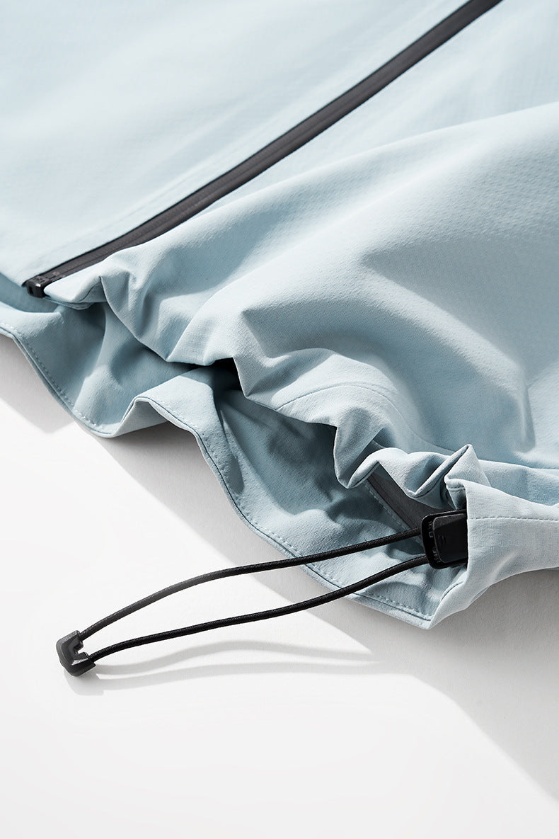 Sky blue windbreaker jacket hood brim and drawcord stopper detail