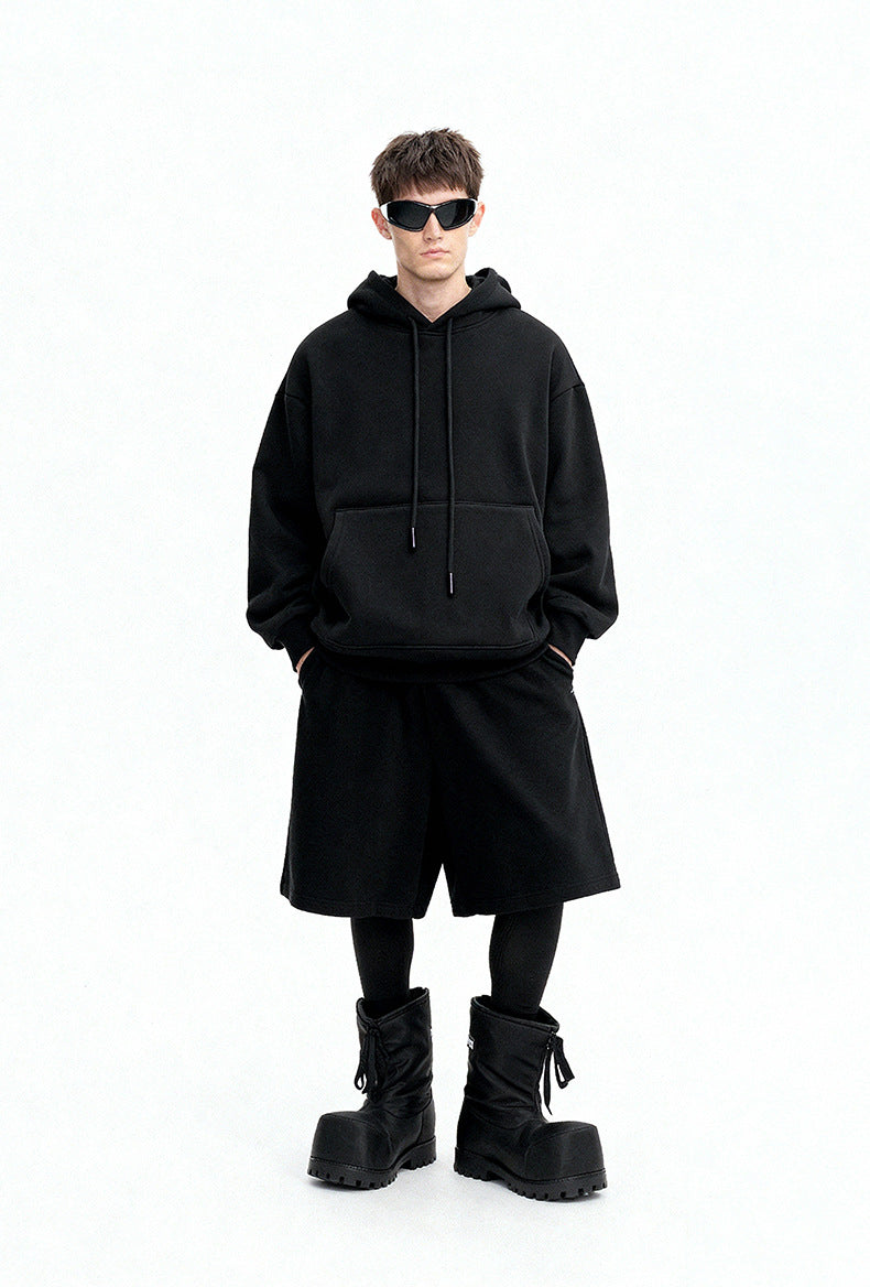 Black oversized hoodie front view on model, minimal street look