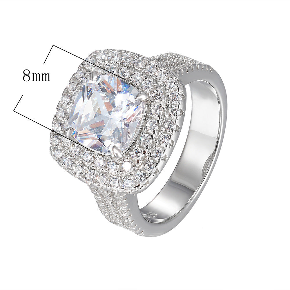 A silver cushion-cut halo engagement ring with 8mm center stone dimension marker, featuring double diamond halo and pave band
