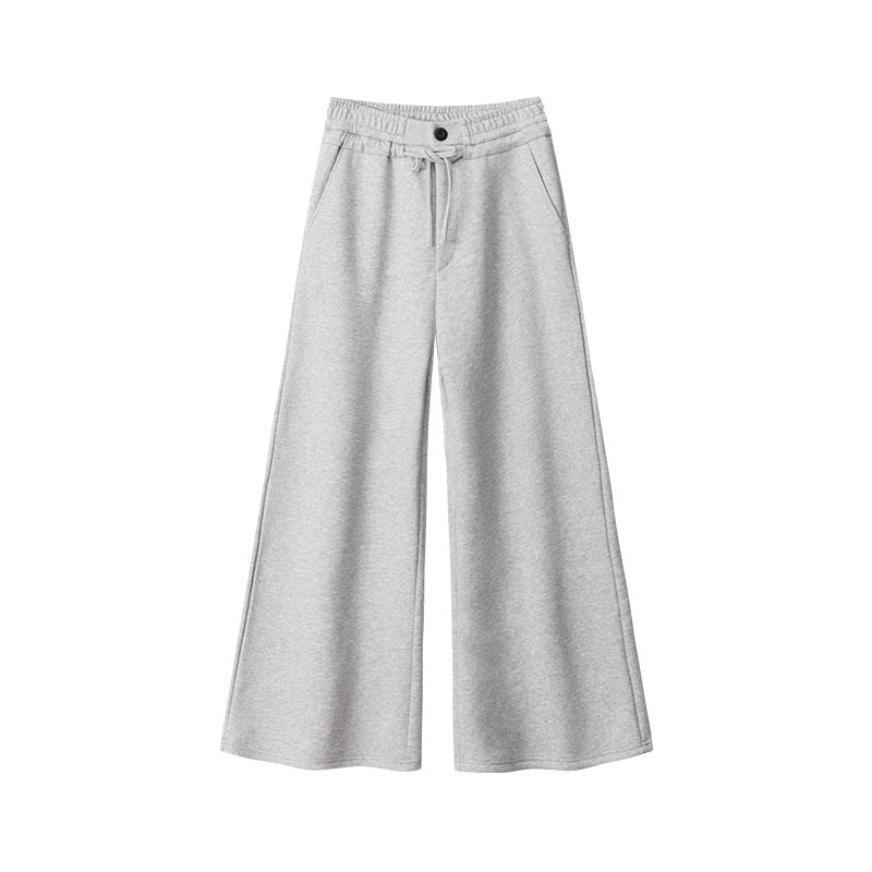 Charcoal gray wide-leg sweatpants with elastic waistband, drawstring tie, and button detail, featuring side pockets and relaxed flared silhouette