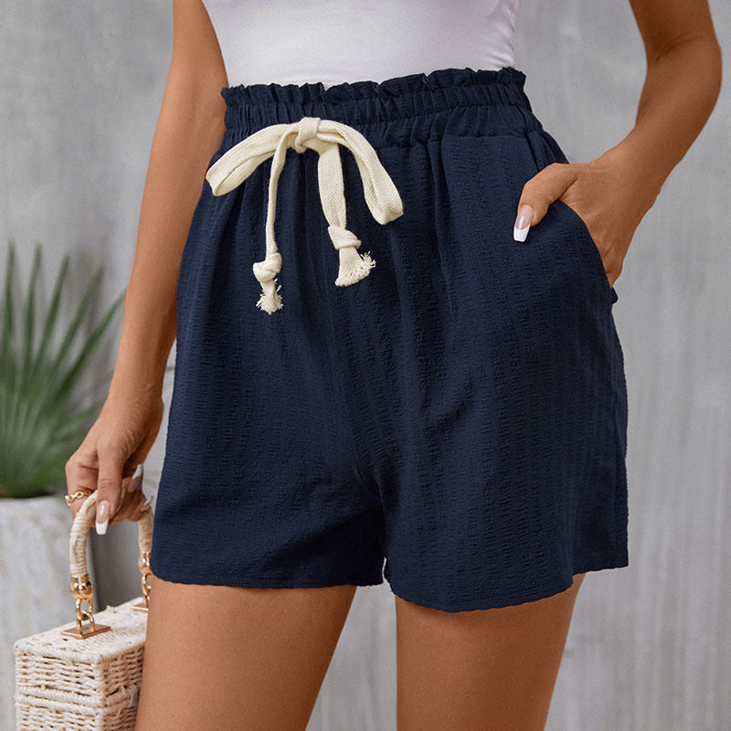 Navy casual shorts with white contrast drawstring and side pockets, styled with white top