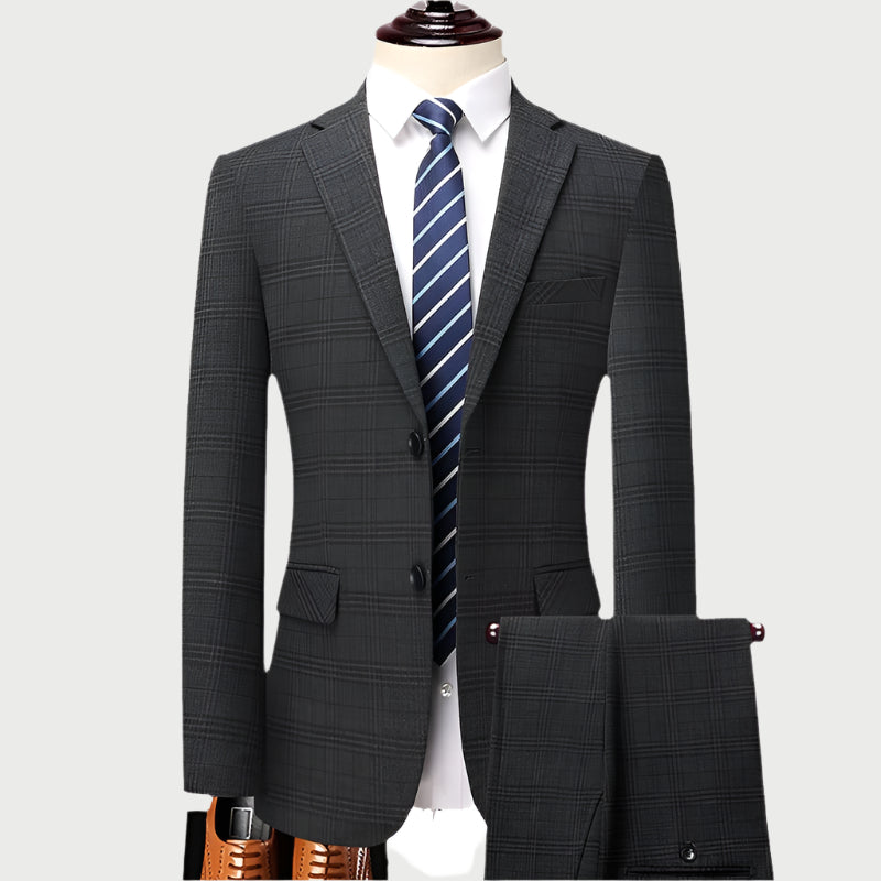 Charcoal gray plaid suit on mannequin with white shirt and blue striped tie against light background