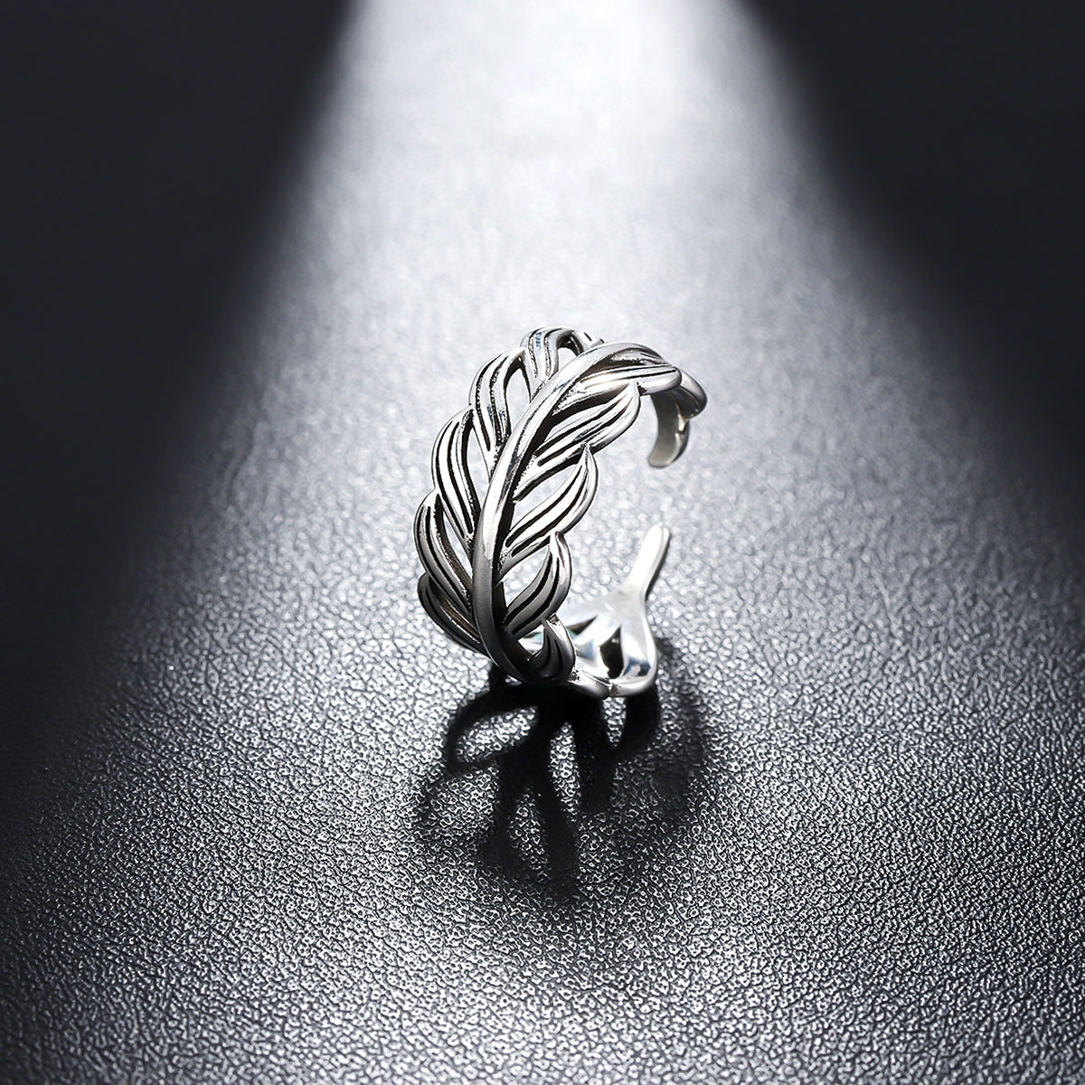 Adjustable feather ring with vintage boho design, crafted in silver-tone metal. A stylish statement band perfect for effortless, chic accessorizing.