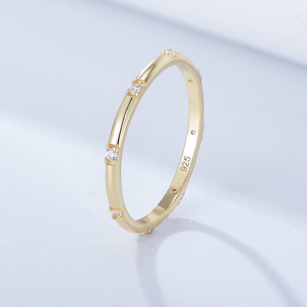 Gold band with small diamond accents shown against white background, stamped 925