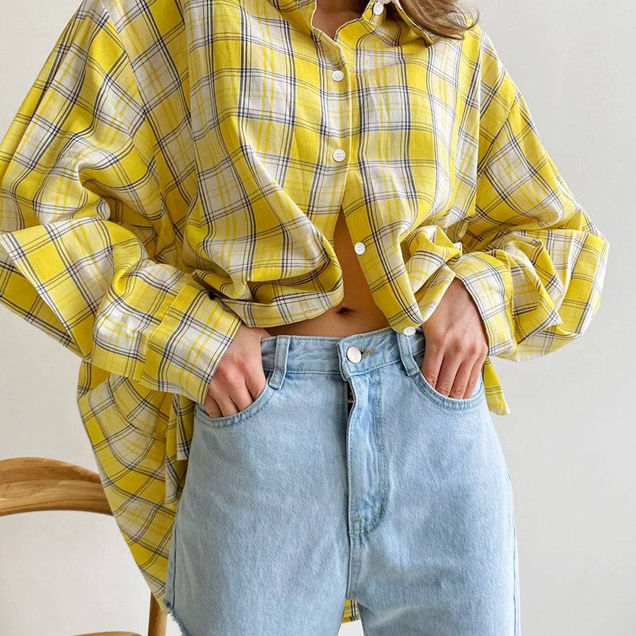 Oversized yellow plaid shirt with cropped styling, paired with light blue denim jeans