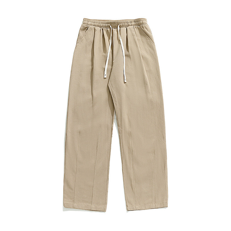 A pair of beige wide-leg drawstring pants with an elastic waistband and white drawstrings, displayed flat on a white background