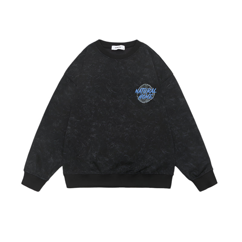 Flat lay of black acid-washed sweatshirt with small chest logo