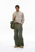 Army green cargo pants on model front view, hands in pockets