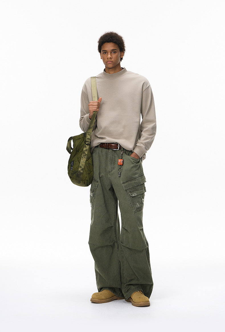 Army green cargo pants on model front view, hands in pockets