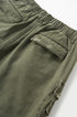 Army green cargo pants pocket flap and seam detail, textured cotton