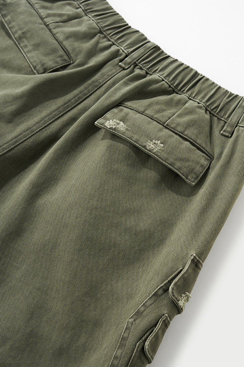 Army green cargo pants pocket flap and seam detail, textured cotton
