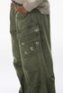 Army green cargo pants side view with multi cargo pockets and light distress