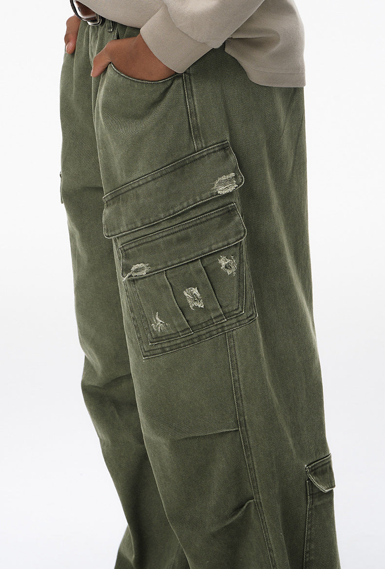 Army green cargo pants side view with multi cargo pockets and light distress