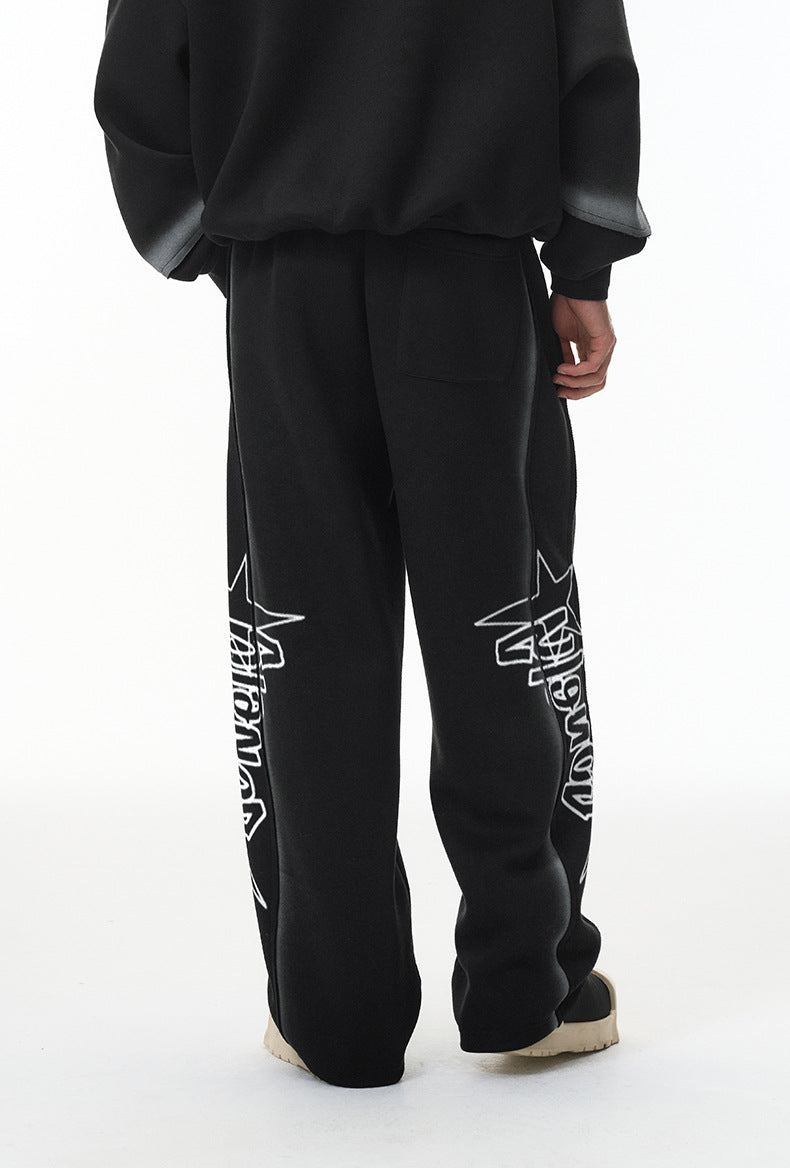 Back view—black baggy sweatpants with straight leg and stacked hem.