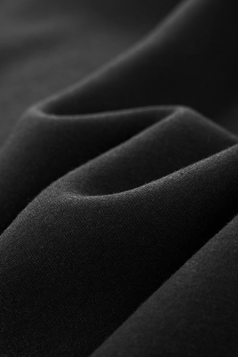 Fabric close-up—soft cotton-blend fleece, black color, midweight hand.