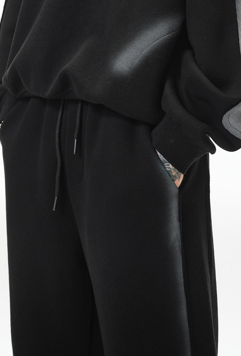 Pocket detail—slant pocket and drawstring waistband on black fleece sweatpants.