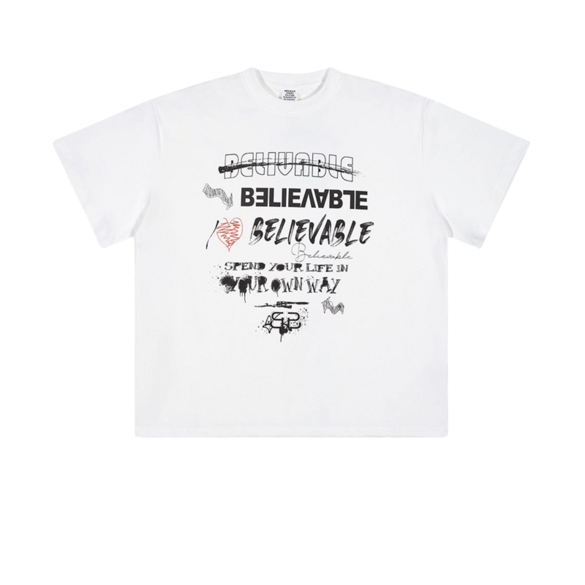 White oversized T-shirt with mixed 'Believable' typography designs laid flat on textured background.