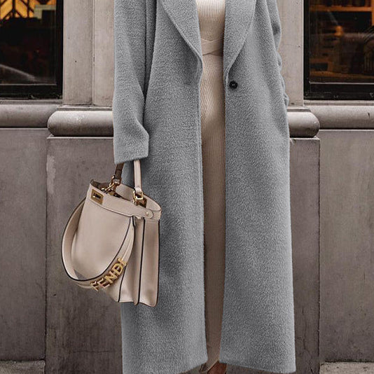 Woman in long gray teddy lapel coat, slim fit—best winter coats street look