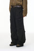 Person wearing black cargo pants with a plaid shirt on a white background