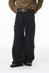 Person wearing black cargo pants and a patterned shirt on a white background