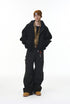 Black cargo pants full body on model with jacket, relaxed street fit