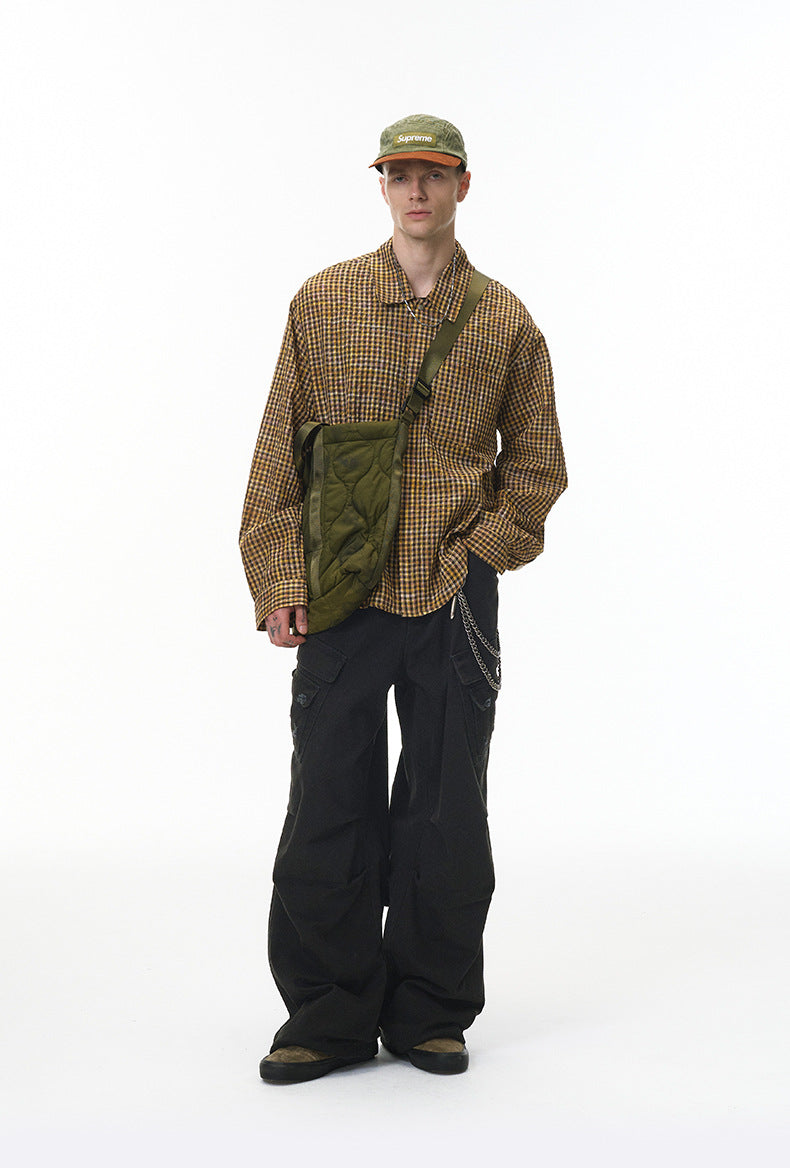 Model in plaid shirt wearing black cargo pants, front full body