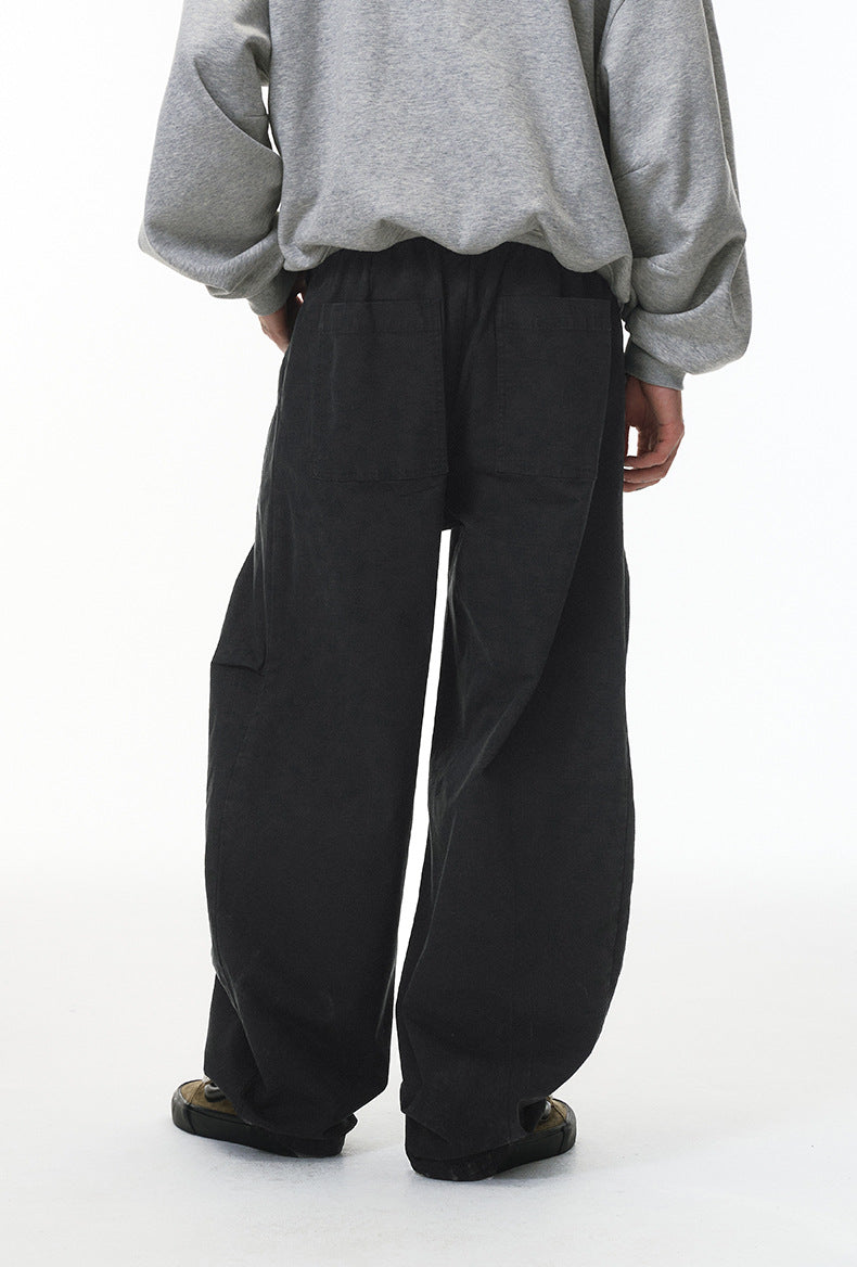 Black corduroy pants back view on model, relaxed wide leg