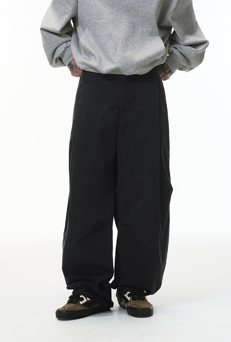 Black corduroy pants side view on model, wide leg with straight cuff
