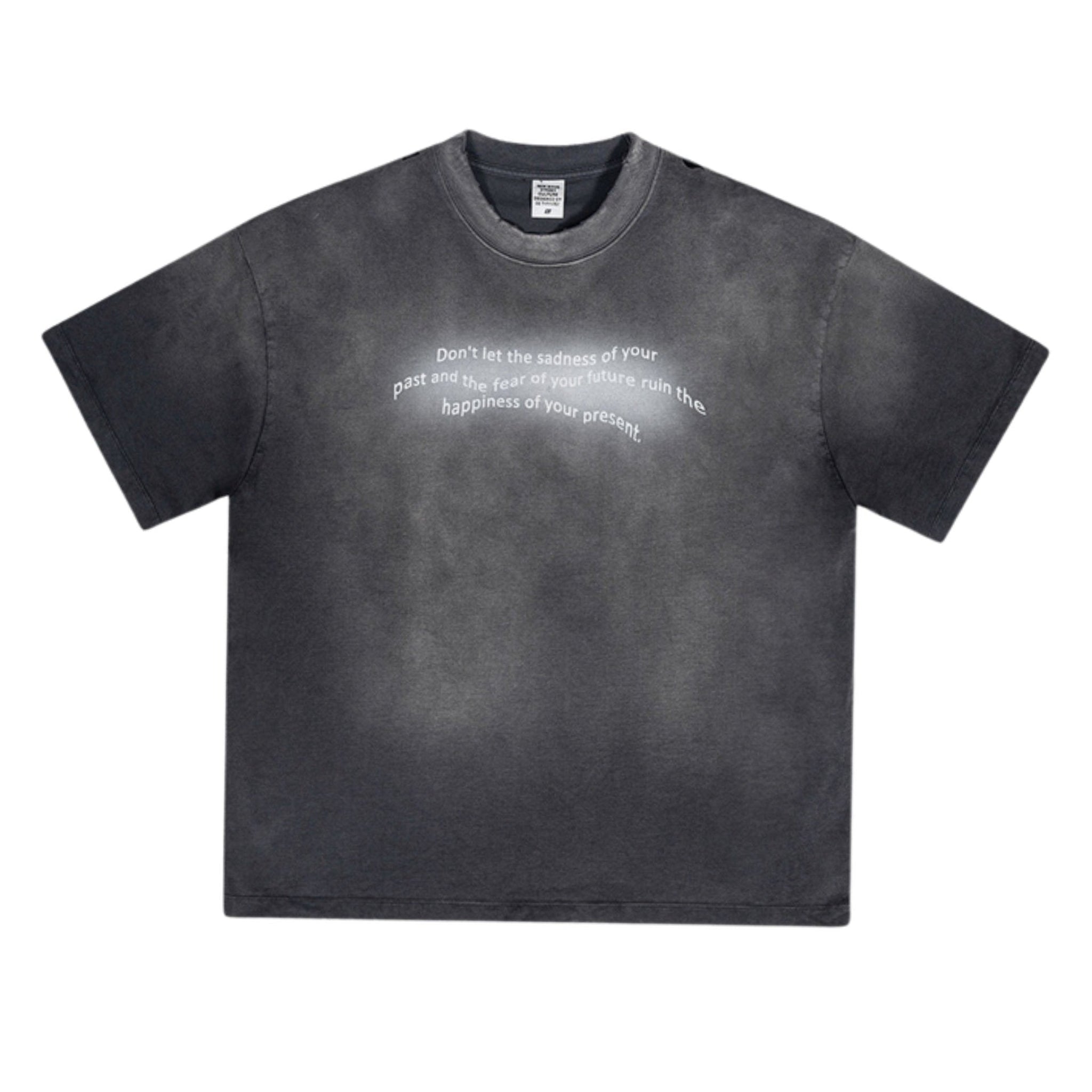 Black oversized tee with white motivational quote text, displayed on textured background.