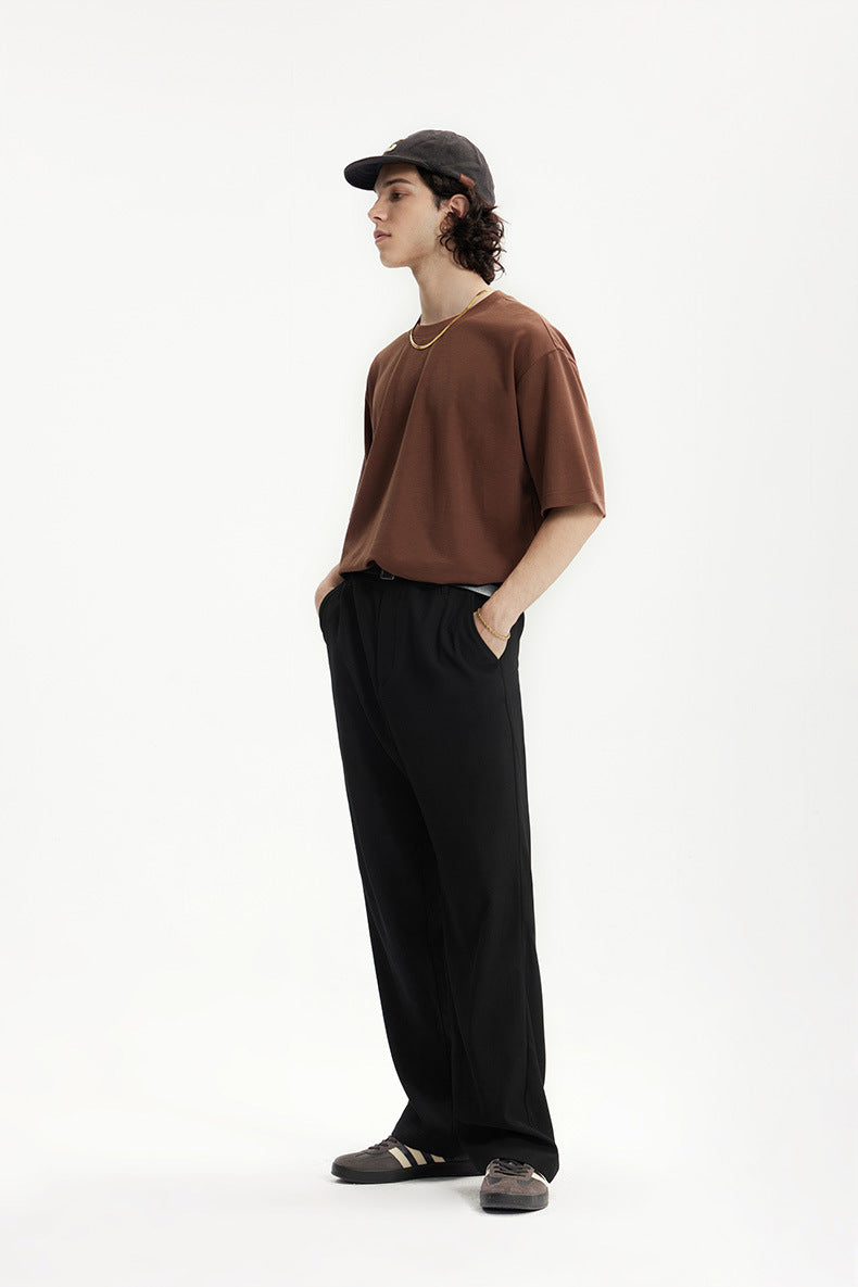 Side profile of black mens dress pants with brown T-shirt outfit