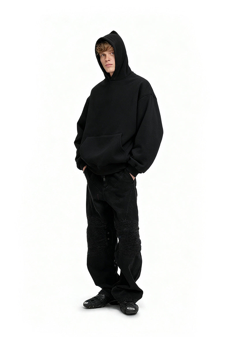 Black oversized hoodie side view on model, drop shoulder fit