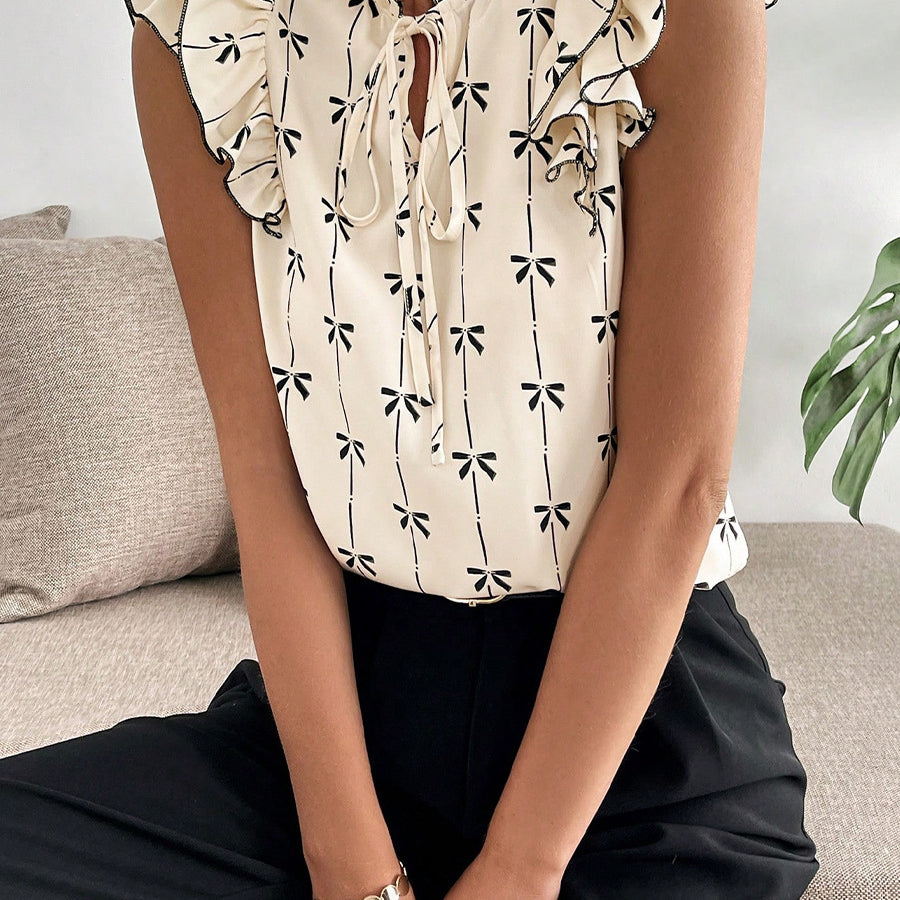 Bow print short sleeve blouse with ruffle sleeves women’s casual top sitting view