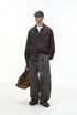 Model in charcoal corduroy pants with plaid shirt, relaxed street fit