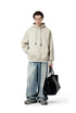 Cream oversized hoodie front view on model, relaxed street fit