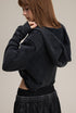 Black cropped hoodie, back view—short length, clean finish.
