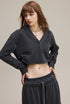 Dark gray cropped hoodie, side profile—clean front, drop shoulder.