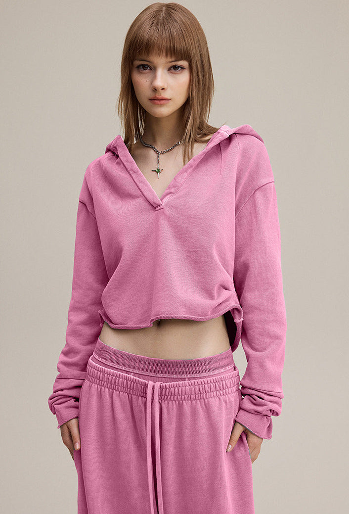 Rose pink cropped hoodie,front view—relaxed fit with raw hem.