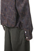 Dark-brown plaid shirt cuff and sleeve hem detail, elastic look