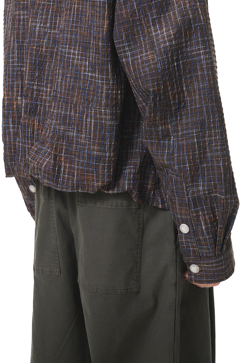 Dark-brown plaid shirt cuff and sleeve hem detail, elastic look