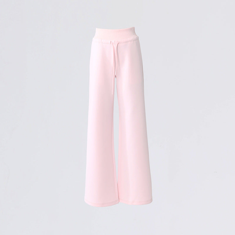 Flat lay of pink high waist wide leg lounge pants with drawstring and seamless finish.