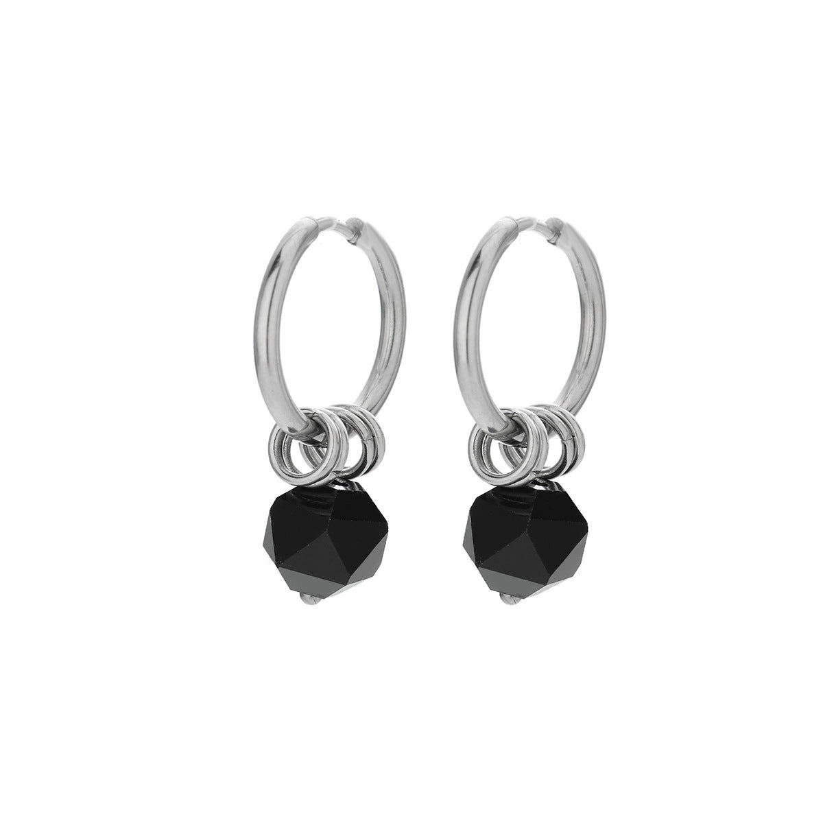Symmetrical silver hoop earrings with black zircon stones on white background.