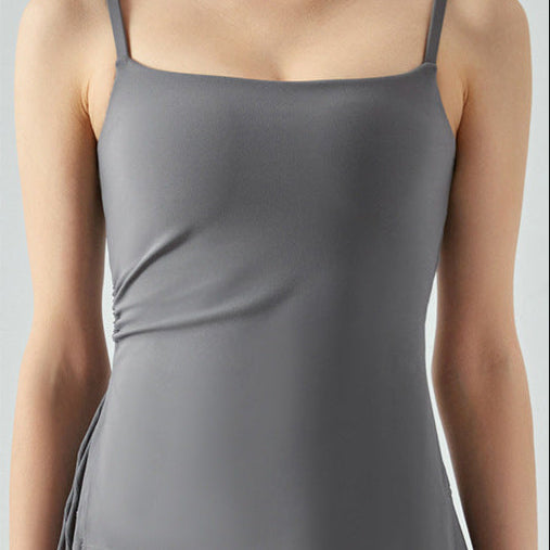 Woman in titanium gray cooling tank top featuring side ruching.